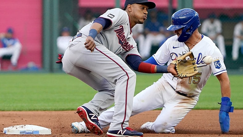 Jun 4, 2021; Kansas City, Missouri, USA; Minnesota Twins shortstop Jorge Polanco (11) can   t make the tag as Kansas City Royals second baseman Whit Merrifield (15) steals second base in the first inning at Kauffman Stadium. Mandatory Credit: Denny Medley-USA TODAY Sports