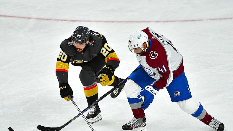 Jun 4, 2021; Las Vegas, Nevada, USA; Colorado Avalanche center Pierre-Edouard Bellemare (41) tips the puck off the stick of Vegas Golden Knights center Chandler Stephenson (20) during the first period of game three of the second round of the 2021 Stanley Cup Playoffs at T-Mobile Arena. Mandatory Credit: Stephen R. Sylvanie-USA TODAY Sports