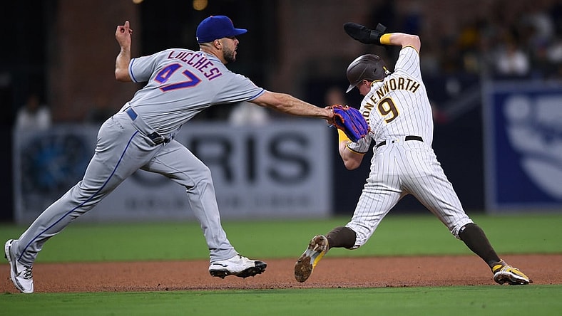 Jun 4, 2021; San Diego, California, USA; San Diego Padres second baseman Jake Cronenworth (9) is called out on a fielder s choice as New York Mets starting pitcher Joey Lucchesi (47) attempts the tag during the fourth inning at Petco Park. Mandatory Credit: Orlando Ramirez-USA TODAY Sports