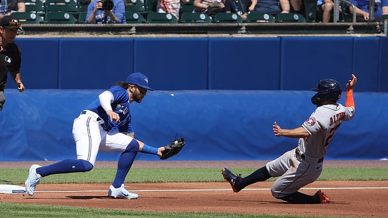 Jun 5, 2021; Buffalo, New York, USA; Toronto Blue Jays shortstop Bo Bichette (11) tags out Houston Astros second baseman Jose Altuve (27) attempting to steal third base during the first inning at Sahlen Field. Mandatory Credit: Timothy T. Ludwig-USA TODAY Sports