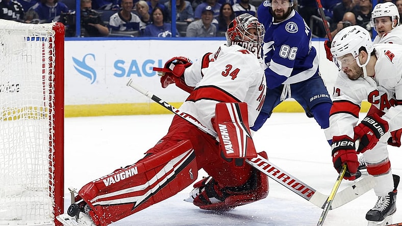 Jun 5, 2021; Tampa, Florida, USA; Carolina Hurricanes goaltender Petr Mrazek (34) makes a save against the Tampa Bay Lightning during the first period in game four of the second round of the 2021 Stanley Cup Playoffs at Amalie Arena. Mandatory Credit: Kim Klement-USA TODAY Sports