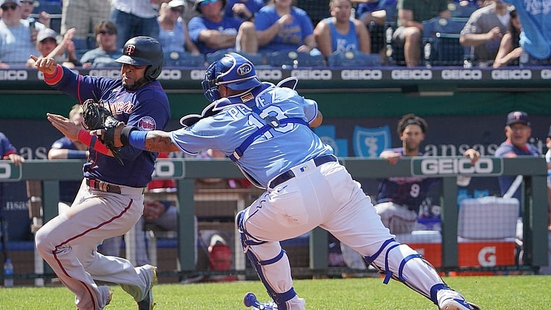 Jun 5, 2021; Kansas City, Missouri, USA; Kansas City Royals catcher Salvador Perez (13) tags out Minnesota Twins designated hitter Nelson Cruz (23) as he tries to score in the third inning at Kauffman Stadium. Mandatory Credit: Denny Medley-USA TODAY Sports