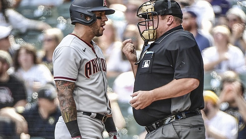 Jun 5, 2021; Milwaukee, Wisconsin, USA; Arizona Diamondbacks left fielder David Peralta (left) talks with home plate umpire Bruce Dreckman (right) after being called out on strikes during the third inning against the Milwaukee Brewers at American Family Field. Mandatory Credit: Benny Sieu-USA TODAY Sports