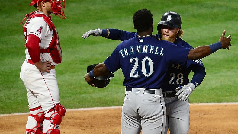 Jun 5, 2021; Anaheim, California, USA; Seattle Mariners designated hitter Jake Fraley (28) is greeted by left fielder Taylor Trammell (20) after hitting a grand slam home run against the Los Angeles Angels during the fourth inning at Angel Stadium. Mandatory Credit: Gary A. Vasquez-USA TODAY Sports