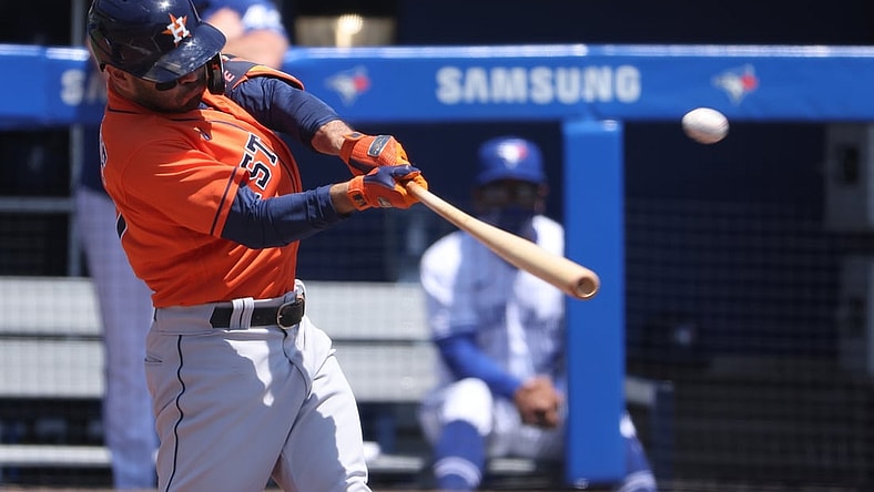 Jun 6, 2021; Buffalo, New York, USA;  Houston Astros second baseman Jose Altuve (27) hits a home run during the first inning against the Toronto Blue Jays at Sahlen Field. Mandatory Credit: Timothy T. Ludwig-USA TODAY Sports