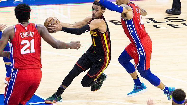 Jun 6, 2021; Philadelphia, Pennsylvania, USA; Atlanta Hawks guard Trae Young (11) drives against Philadelphia 76ers forward Danny Green (14) and center Joel Embiid (21) during the third quarter of game one in the second round of the 2021 NBA Playoffs at Wells Fargo Center. Mandatory Credit: Bill Streicher-USA TODAY Sports