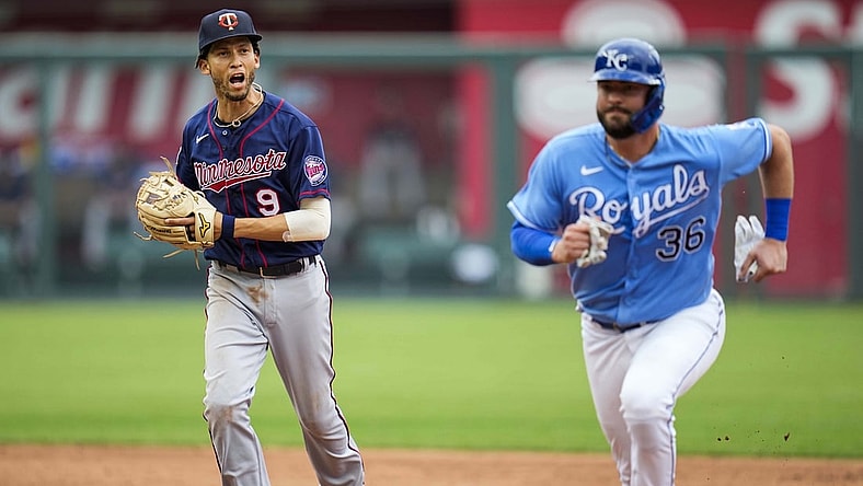 Jun 6, 2021; Kansas City, Missouri, USA; Minnesota Twins shortstop Andrelton Simmons (9) runs down Kansas City Royals catcher Cam Gallagher (36) to complete a triple play during the third inning at Kauffman Stadium. Mandatory Credit: Jay Biggerstaff-USA TODAY Sports