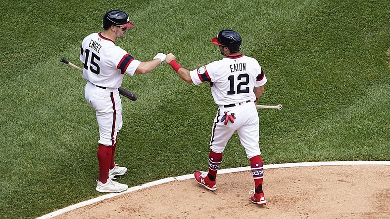 Jun 6, 2021; Chicago, Illinois, USA; Chicago White Sox right fielder Adam Eaton (12) is greeted by center fielder Adam Engel (15) after scoring against the Detroit Tigers during the second inning at Guaranteed Rate Field. Mandatory Credit: David Banks-USA TODAY Sports