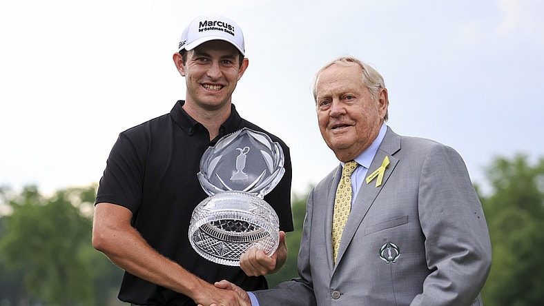 Jun 6, 2021; Dublin, Ohio, USA; Patrick Cantlay (left) holds the trophy as he shakes hands with Jack Nicklaus with after winning the Memorial Tournament golf tourney. Mandatory Credit: Aaron Doster-USA TODAY Sports