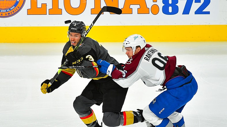 Jun 6, 2021; Las Vegas, Nevada, USA; Vegas Golden Knights defenseman Brayden McNabb (3) eyes the puck while taking a check from Colorado Avalanche right wing Mikko Rantanen (96) during the first period of game four of the second round of the 2021 Stanley Cup Playoffs at T-Mobile Arena. Mandatory Credit: Stephen R. Sylvanie-USA TODAY Sports