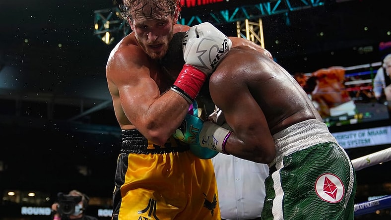 Jun 6, 2021; Miami, Florida, USA; Floyd Mayweather Jr. (Green Trunks) fights Logan Paul (Yellow Trunks) during an exhibition boxing match at Hard Rock Stadium. Mandatory Credit: Jasen Vinlove-USA TODAY Sports