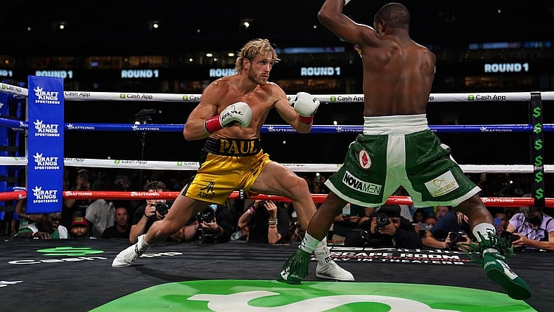 Jun 6, 2021; Miami, Florida, USA; Floyd Mayweather Jr. (Green Trunks) fights Logan Paul (Yellow Trunks) during an exhibition boxing match at Hard Rock Stadium. Mandatory Credit: Jasen Vinlove-USA TODAY Sports