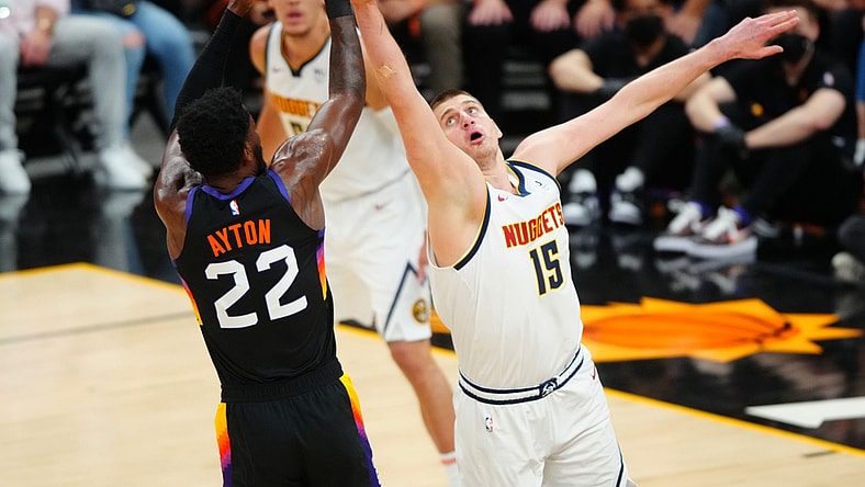 Jun 7, 2021; Phoenix, Arizona, USA; Denver Nuggets center Nikola Jokic (15) defends against Phoenix Suns center Deandre Ayton (22) in the first half during game one in the second round of the 2021 NBA Playoffs at Phoenix Suns Arena. Mandatory Credit: Mark J. Rebilas-USA TODAY Sports
