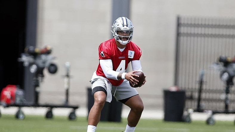 Jun 8, 2021; Frisco, TX, USA; Dallas Cowboys quarterback Dak Prescott (4) goes through drills during voluntary Organized Team Activities at the Ford Center at the Star Training Facility in Frisco, Texas. Mandatory Credit: Tim Heitman-USA TODAY Sports