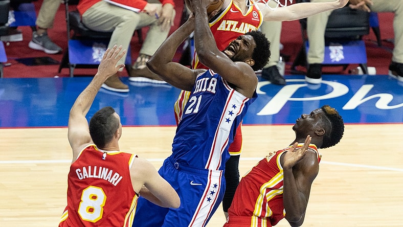 Jun 8, 2021; Philadelphia, Pennsylvania, USA; Philadelphia 76ers center Joel Embiid (21) drives for a shot against Atlanta Hawks center Clint Capela (15) and forward Danilo Gallinari (8) during the first quarter in game two of the second round of the 2021 NBA Playoffs at Wells Fargo Center. Mandatory Credit: Bill Streicher-USA TODAY Sports