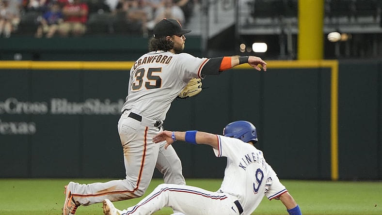 Jun 8, 2021; Arlington, Texas, USA; San Francisco Giants shortstop Brandon Crawford (35) throws to first base after forcing out Texas Rangers shortstop Isiah Kiner-Falefa (9) completing the double play during the third inning at Globe Life Field. Mandatory Credit: Jim Cowsert-USA TODAY Sports