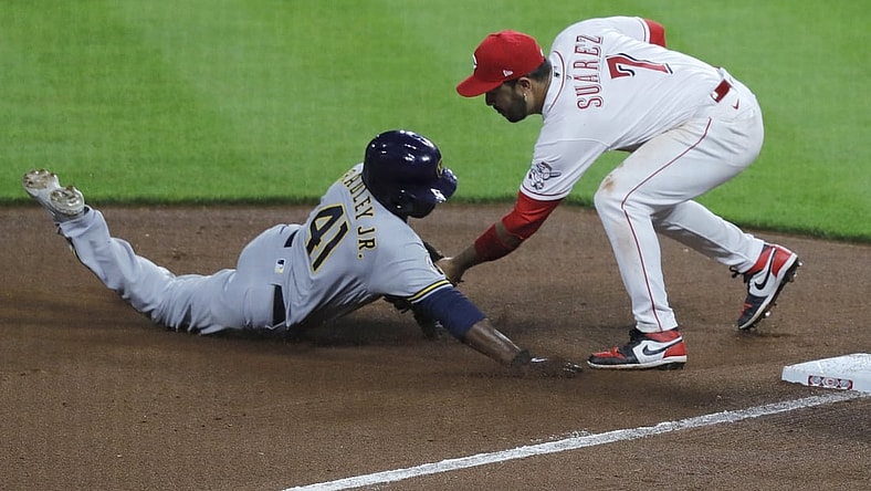 Jun 8, 2021; Cincinnati, Ohio, USA; Milwaukee Brewers center fielder Jackie Bradley Jr. (41) is tagged out at third by Cincinnati Reds third baseman Eugenio Suarez (7) during the seventh inning at Great American Ball Park. Mandatory Credit: David Kohl-USA TODAY Sports