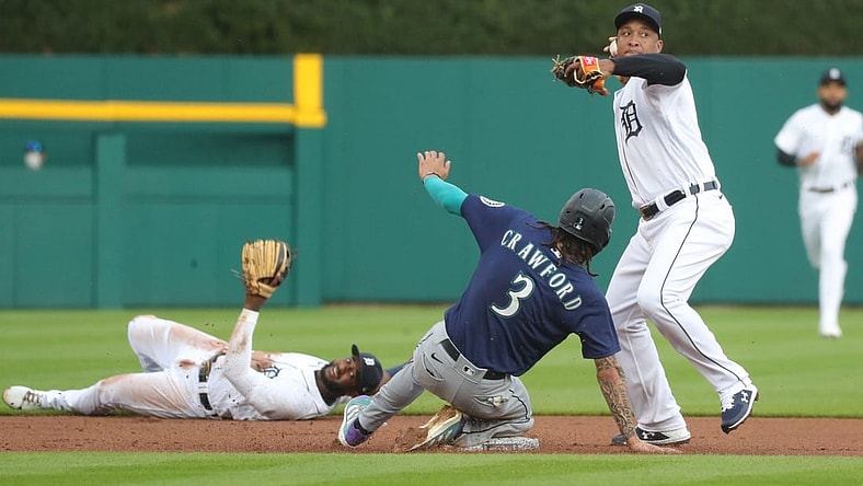 Detroit Tigers shortstop Niko Goodrum (28) flip the ball to second baseman Jonathan Schoop (7) for the force out on Seattle Mariners shortstop J.P. Crawford (3) during first inning action Tuesday, June 8, 2021, at Comerica Park in Detroit.

Tigers