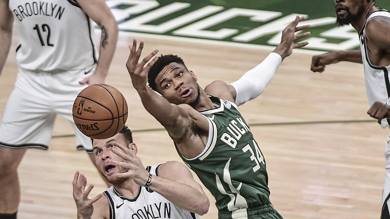 Jun 10, 2021; Milwaukee, Wisconsin, USA; Milwaukee Bucks forward Giannis Antetokounmpo (34) and Brooklyn Nets forward Blake Griffin (2) reach for a rebound in the first quarter during game three in the second round of the 2021 NBA Playoffs at Fiserv Forum. Mandatory Credit: Benny Sieu-USA TODAY Sports