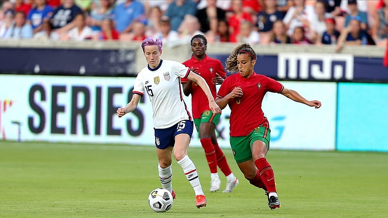 Jun 10, 2021; Houston, Texas, USA; United States forward Megan Rapinoe (15) advances the ball upfield while Portugal midfielder Andreia Jacinto (6) defends during the first half of a WNT Summer Series international friendly soccer match at BBVA Stadium. Mandatory Credit: Erik Williams-USA TODAY Sports