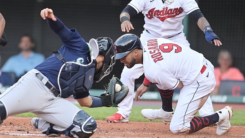 Jun 11, 2021; Cleveland, Ohio, USA; Seattle Mariners catcher Jose Godoy (78) tags out Cleveland Indians left fielder Eddie Rosario (9) during the first inning at Progressive Field. Mandatory Credit: Ken Blaze-USA TODAY Sports