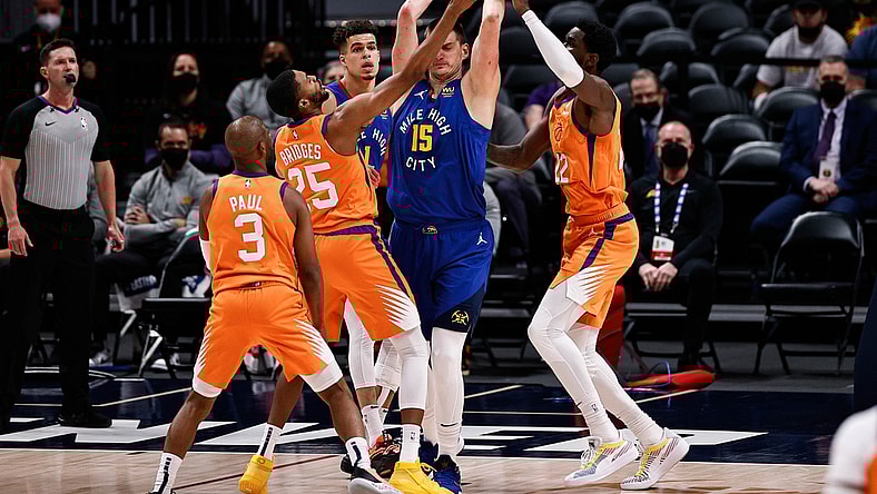 Jun 11, 2021; Denver, Colorado, USA; Denver Nuggets center Nikola Jokic (15) is defended by Phoenix Suns center Deandre Ayton (22) and forward Mikal Bridges (25) as guard Chris Paul (3) and forward Michael Porter Jr. (1) look on in the first quarter during game three in the second round of the 2021 NBA Playoffs at Ball Arena. Mandatory Credit: Isaiah J. Downing-USA TODAY Sports