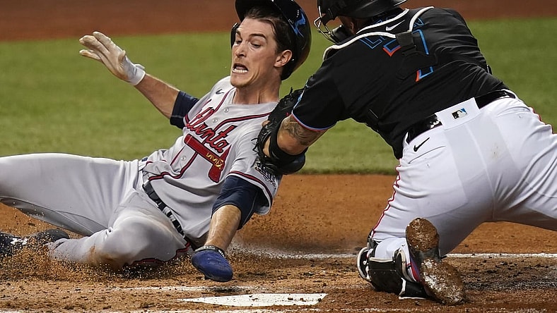 Jun 12, 2021; Miami, Florida, USA; Miami Marlins catcher Sandy Leon (7) tags out Atlanta Braves starting pitcher Max Fried (54) at the plate in the 3rd inning at loanDepot park. Mandatory Credit: Jasen Vinlove-USA TODAY Sports