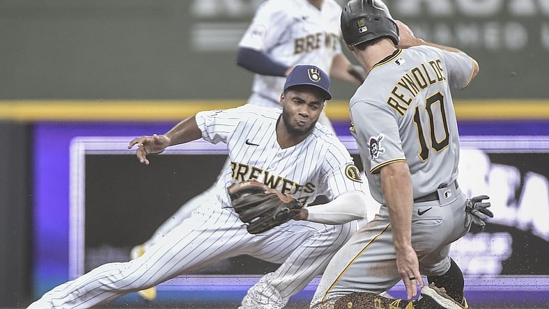 Jun 12, 2021; Milwaukee, Wisconsin, USA; Pittsburgh Pirates center fielder Bryan Reynolds (10) steals second base ahead of the tag by Milwaukee Brewers third baseman Pablo Reyes (left) during the third inning at American Family Field. Mandatory Credit: Benny Sieu-USA TODAY Sports