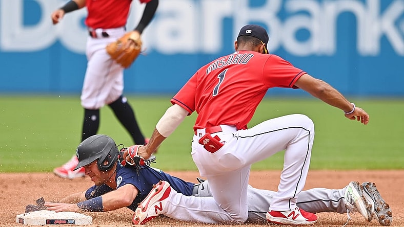 Jun 13, 2021; Cleveland, Ohio, USA; Seattle Mariners second baseman Dylan Moore (25) is caught stealing by Cleveland Indians shortstop Amed Rosario (1) during the third inning at Progressive Field. Mandatory Credit: Ken Blaze-USA TODAY Sports