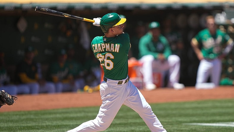 Jun 13, 2021; Oakland, California, USA;  Oakland Athletics third baseman Matt Chapman (26) hits a solo home run during the first inning against the Kansas City Royals at RingCentral Coliseum. Mandatory Credit: Stan Szeto-USA TODAY Sports