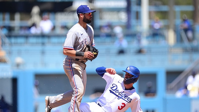 Jun 13, 2021; Los Angeles, California, USA; Los Angeles Dodgers second baseman Chris Taylor (3) reaches second against Texas Rangers shortstop Isiah Kiner-Falefa (9) during the third inning at Dodger Stadium. Mandatory Credit: Gary A. Vasquez-USA TODAY Sports