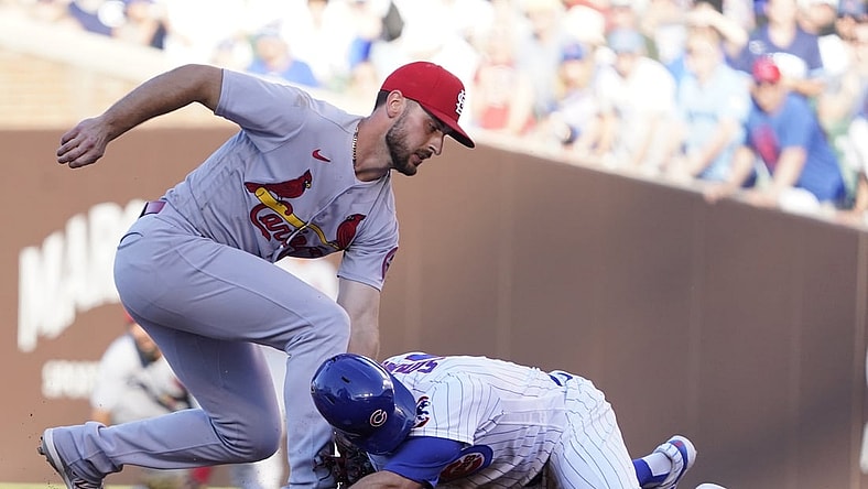 Jun 13, 2021; Chicago, Illinois, USA; Chicago Cubs second baseman Eric Sogard (4) is safe at second base with a double as St. Louis Cardinals shortstop Paul DeJong (11) makes a late tag during the third inning at Wrigley Field. Mandatory Credit: David Banks-USA TODAY Sports