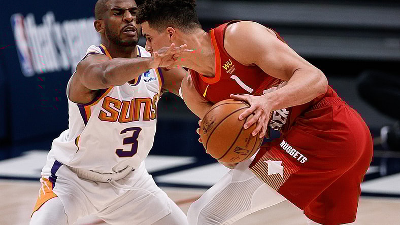 Jun 13, 2021; Denver, Colorado, USA; Denver Nuggets forward Michael Porter Jr. (1) controls the ball as Phoenix Suns guard Chris Paul (3) defends in the second quarter during game four in the second round of the 2021 NBA Playoffs at Ball Arena. Mandatory Credit: Isaiah J. Downing-USA TODAY Sports