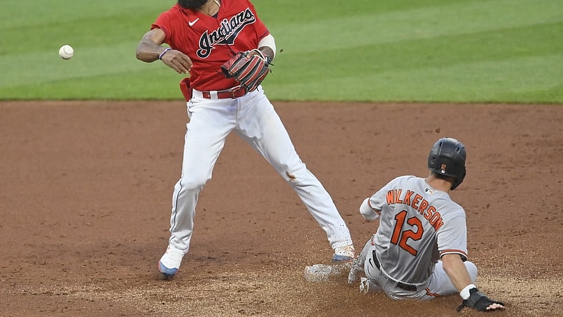 Jun 14, 2021; Cleveland, Ohio, USA; Cleveland Indians shortstop Amed Rosario (1) turns a double play against Baltimore Orioles second baseman Stevie Wilkerson (12) in the third inning at Progressive Field. Mandatory Credit: David Richard-USA TODAY Sports