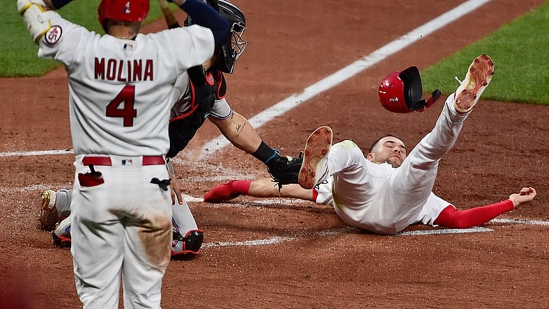 Jun 14, 2021; St. Louis, Missouri, USA;  St. Louis Cardinals center fielder Dylan Carlson (3) is tagged out at home by Miami Marlins catcher Jorge Alfaro (38) as catcher Yadier Molina (4) reacts during the third inning at Busch Stadium. Mandatory Credit: Jeff Curry-USA TODAY Sports
