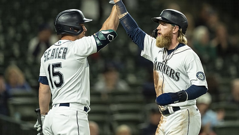 Jun 14, 2021; Seattle, Washington, USA; Seattle Mariners designated hitter Jake Fraley (28) is congratulated by third baseman Kyle Seager (15) after scoring a run on a double by first baseman Ty France (23) off of Minnesota Twins relief pitcher Luke Farrell (51) during the fifth inning of a game at T-Mobile Park. Mandatory Credit: Stephen Brashear-USA TODAY Sports