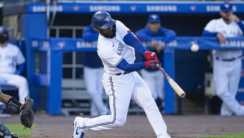 Jun 15, 2021; Buffalo, New York, CAN; Toronto Blue Jays right fielder Teoscar Hernandez (37) hits a sacrifice fly ball to drive in a run during the first inning against the New York Yankees at Sahlen Field. Mandatory Credit: Gregory Fisher-USA TODAY Sports
