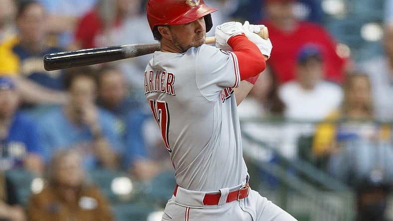 Jun 15, 2021; Milwaukee, Wisconsin, USA;  Cincinnati Reds second baseman Kyle Farmer (17) singles during the third inning against the Milwaukee Brewers at American Family Field. Mandatory Credit: Jeff Hanisch-USA TODAY Sports