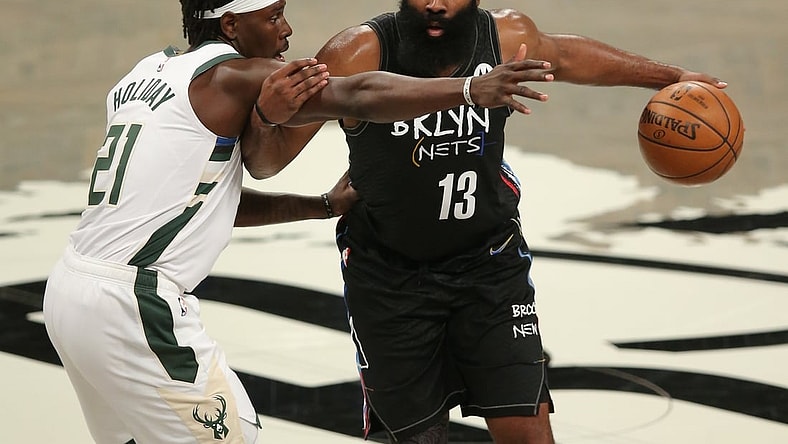 Jun 15, 2021; Brooklyn, New York, USA; Brooklyn Nets shooting guard James Harden (13) controls the ball against Milwaukee Bucks point guard Jrue Holiday (21) during the third quarter of game five of the second round of the 2021 NBA Playoffs at Barclays Center. Mandatory Credit: Brad Penner-USA TODAY Sports