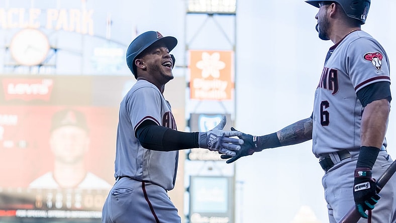 Jun 15, 2021; San Francisco, California, USA; Arizona Diamondbacks center fielder Ketel Marte (4) celebrates with left fielder David Peralta (6) after scoring against the San Francisco Giants in the second inning at Oracle Park. Mandatory Credit: John Hefti-USA TODAY Sports