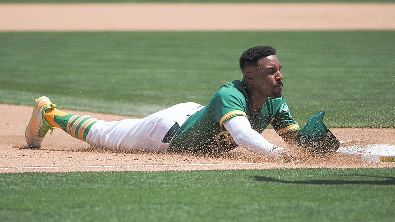 Jun 16, 2021; Oakland, California, USA; Oakland Athletics second baseman Tony Kemp (5) slides to third base against the Los Angeles Angels during the fifth inning at RingCentral Coliseum. Mandatory Credit: Kelley L Cox-USA TODAY Sports