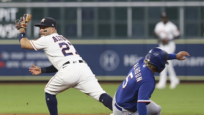 Jun 16, 2021; Houston, Texas, USA; Texas Rangers left fielder Willie Calhoun (5) is forced out at second base by Houston Astros second baseman Jose Altuve (27 in the fifth inning at Minute Maid Park. Mandatory Credit: Thomas Shea-USA TODAY Sports