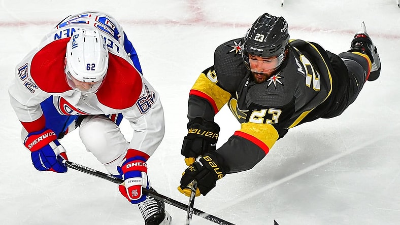 Jun 16, 2021; Las Vegas, Nevada, USA;Vegas Golden Knights defenseman Alec Martinez (23) dives to tip a puck away from the reach of Montreal Canadiens left wing Artturi Lehkonen (62) during the second period of game two of the 2021 Stanley Cup Semifinals at T-Mobile Arena. Mandatory Credit: Stephen R. Sylvanie-USA TODAY Sports