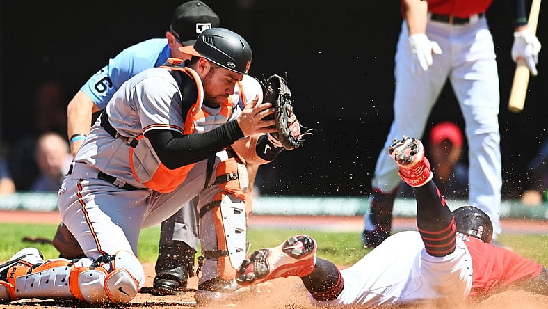 Jun 17, 2021; Cleveland, Ohio, USA; Cleveland Indians third baseman Yu Chang (2) scores as Baltimore Orioles catcher Austin Wynns (61) is late with the tag during the fourth inning at Progressive Field. Mandatory Credit: Ken Blaze-USA TODAY Sports