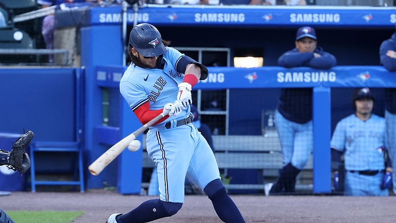 Jun 17, 2021; Buffalo, New York, USA;  Toronto Blue Jays shortstop Bo Bichette (11) hits a base hit during the first inning against the New York Yankees at Sahlen Field. Mandatory Credit: Timothy T. Ludwig-USA TODAY Sports