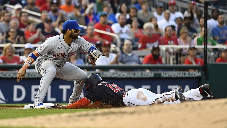 Jun 18, 2021; Washington, District of Columbia, USA; /Washington Nationals center fielder Victor Robles (16) beats the tag by New York Mets third baseman Jonathan Villar (1) during the third inning at Nationals Park. Mandatory Credit: Brad Mills-USA TODAY Sports