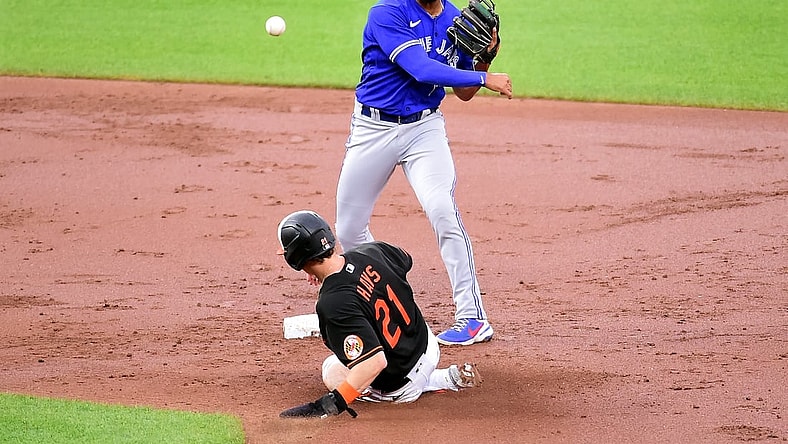 Jun 18, 2021; Baltimore, Maryland, USA; Toronto Blue Jays second baseman Marcus Semien (10) tries to turn a double play over Baltimore Orioles outfielder Austin Hays (21) in the third inning at Oriole Park at Camden Yards. Mandatory Credit: Evan Habeeb-USA TODAY Sports