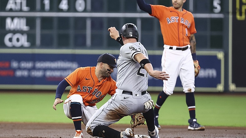 Jun 18, 2021; Houston, Texas, USA; Chicago White Sox catcher Zack Collins (21) is tagged out on a stolen base attempt by Houston Astros second baseman Jose Altuve (27) during the second inning at Minute Maid Park. Mandatory Credit: Troy Taormina-USA TODAY Sports