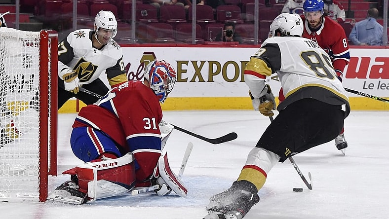 Jun 18, 2021; Montreal, Quebec, CAN; Montreal Canadiens goalie Carey Price (31) stops Vegas Golden Knights forward Jonathan Marchessault (81) and teammate forward Max Pacioretty (67) during the first period in game three of the 2021 Stanley Cup Semifinals at the Bell Centre. Mandatory Credit: Eric Bolte-USA TODAY Sports