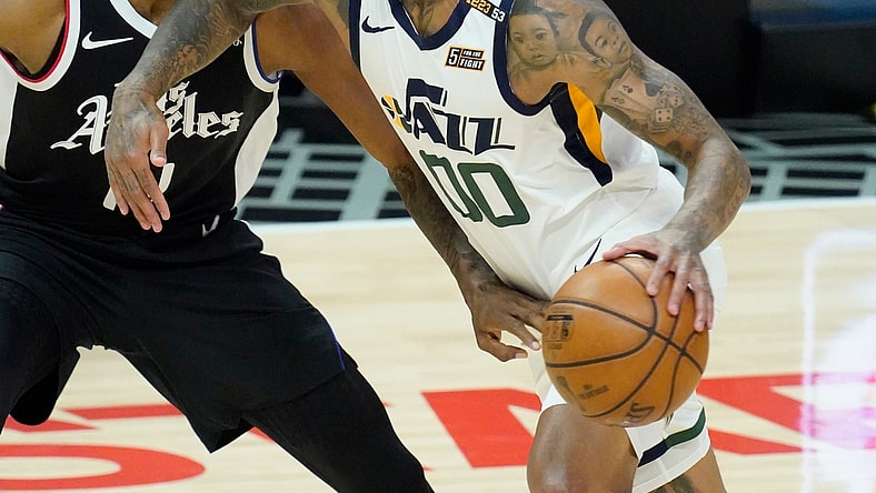 Jun 18, 2021; Los Angeles, California, USA; Utah Jazz guard Jordan Clarkson (00) dribbles the ball past LA Clippers guard Terance Mann (14) in the second quarter during game six in the second round of the 2021 NBA Playoffs at Staples Center. Mandatory Credit: Robert Hanashiro-USA TODAY Sports